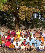 Photo gallery: a large group of women, men and children under a tree