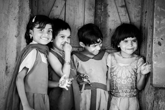 Severe malnutrition control: four smiling young girls (black-and-white photo)