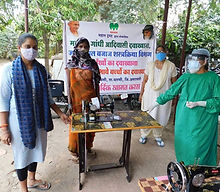 Women beneficiaries with a donated sewing machine