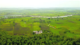 Aerial view of the MAHAN campus among green fields and forest