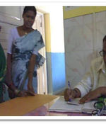 Success stories: a woman being helped at a hospital desk