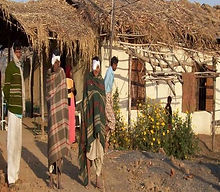 Initial IPD: patients outside a thatched building